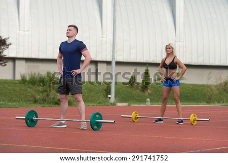 A Group Of Young People In Aerobics Class Doing A Overhead Squat Exercise Outdoor