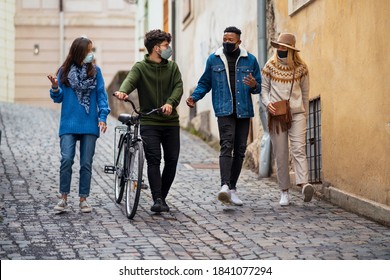 Group of young people with bicycle outdoors in town, walking. Coronavirus concept. - Powered by Shutterstock