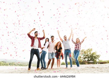 Group Of Young People Celebrating At The Beach