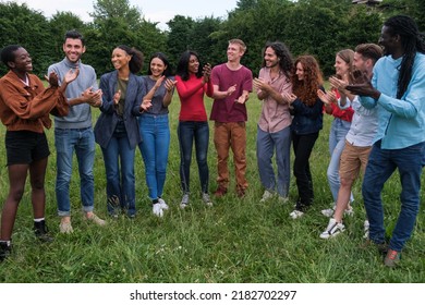 Group Of Young People Clapping And Dancing Outdoors Lifestyle