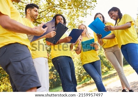 Group of young people with clipboard in strategy planning for a terrain game