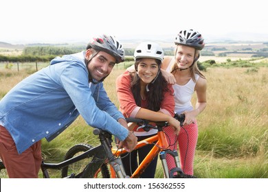 Group Of Young People Cycling In Countryside