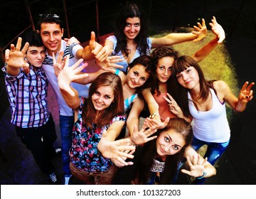 A Group Of Young People Dancing At A Disco.