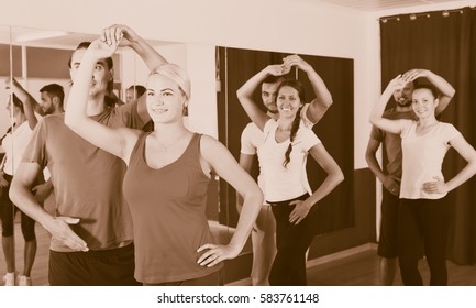 Group of young people dancing salsa in studio - Shutterstock ID 583761148