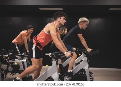 
a group of young people doing sports on stationary bicycles. - Powered by Shutterstock