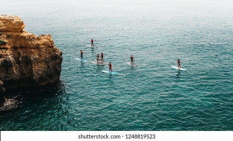 Group of young people doing SUP, Stand up Paddle, in the Algarve.