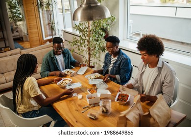 Group Of Young People Eating Out And Talking, Having Fun At Home