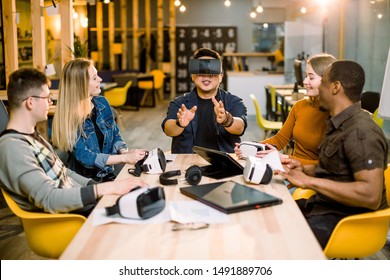 Group Of Young People Employee Workers Having Fun With Vr Virtual Reality Goggles In Startup Studio. Young Chinese Man Wearing VR Glasses.