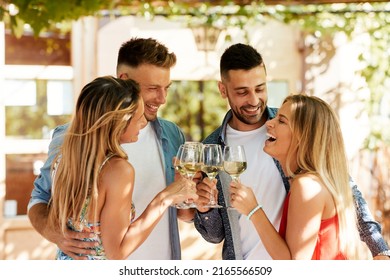 Group of young people enjoy and drink white wine in backyard during a summer sunny day - Shutterstock ID 2165566509
