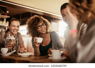 Group of young people enjoying a coffee in a cafe - Powered by Shutterstock