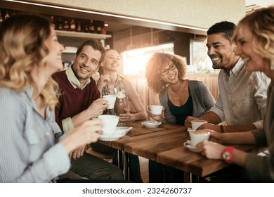 Group of young people enjoying a coffee in a cafe - Powered by Shutterstock