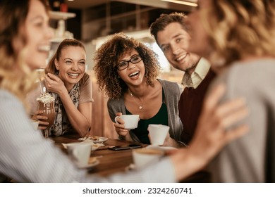 Group of young people enjoying a coffee in a cafe - Powered by Shutterstock