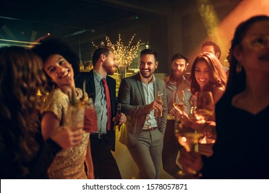 Group of young people enjoying at a nightclub - Powered by Shutterstock