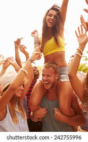 Group Of Young People Enjoying Outdoor Music Festival