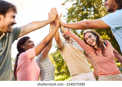 Group of young people giving high five for friendship and cooperation - Shutterstock ID 2140275585
