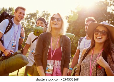 Group Of Young People Going Camping At Music Festival