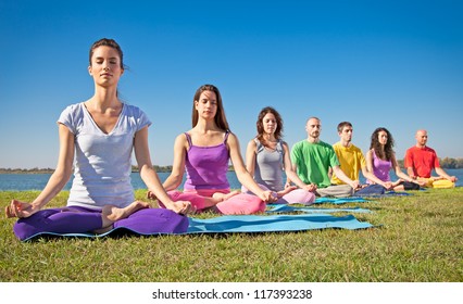 Group Of Young People Have Meditation On Yoga Class. Yoga Concept.