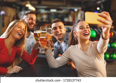 Group of young people having fun in a night and taking selfie - Powered by Shutterstock