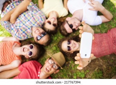 Group of young people having fun in park, lying on the grass - Powered by Shutterstock