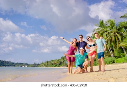 Group of young people having fun on the beach together. Vacation with friends. - Shutterstock ID 435702910