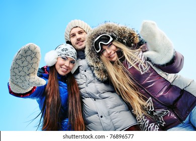 Group Of Young People Having A Rest Outdoor In Winter.