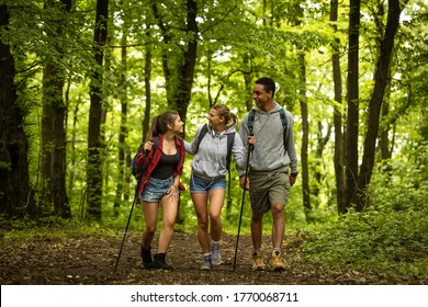 Group Of Young People Hiking Trough Forest.Outdoors Nature Concept.	
