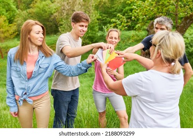 Group Of Young People Holding Colorful Cards At Team Building Outdoor Workshop In Nature