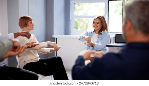 Group Of Young People Learning Deaf Gesture Sign From Woman - Powered by Shutterstock