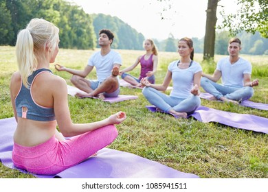 Group Of Young People In Mediation Workshop In Summer In Nature