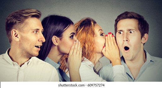 Group of young people men and women whispering each other in the ear. Word of mouth concept  - Shutterstock ID 609757274