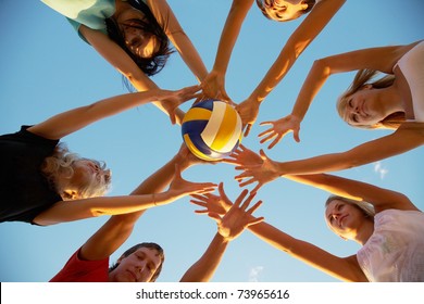 group of young people playing volleyball on the beach - Powered by Shutterstock