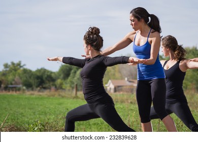 Group Of Young People Practicing In An Outdoor Yoga Class