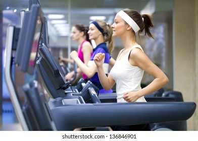 group of young people running on treadmill in gym - Powered by Shutterstock