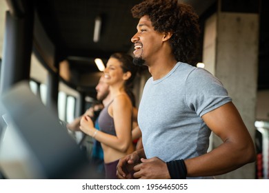 Group of young people running on treadmills in sport gym - Powered by Shutterstock