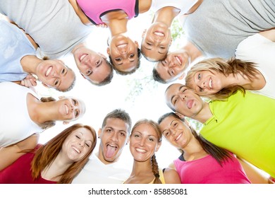 Group Of Young People Smiling And Holding Heads Together