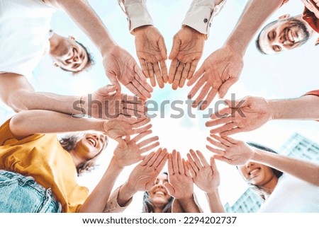 Group of young people stacking hands outdoors - Teamwork concept with guys and girls support each other - College students standing together outside 