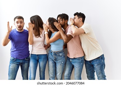 Group Of Young People Standing Together Over Isolated Background Hand On Mouth Telling Secret Rumor, Whispering Malicious Talk Conversation 