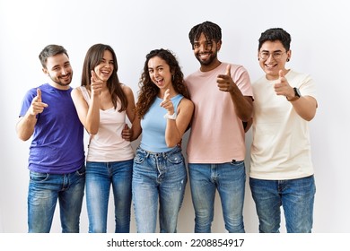 Group Of Young People Standing Together Over Isolated Background Pointing Fingers To Camera With Happy And Funny Face. Good Energy And Vibes. 