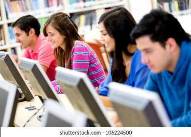 Group Of Young People Studying At The Library Using Computers