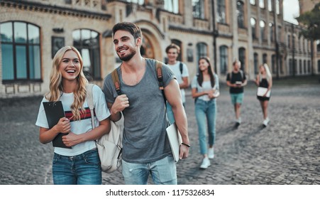 Group of young people are studying together in university. Students outdoors. - Shutterstock ID 1175326834