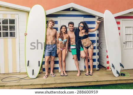 Similar – Young friends holding woman on top of surfboard