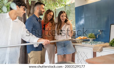 Similar – Gruppe von Freunden, die bei einem Sommergrill kochen.