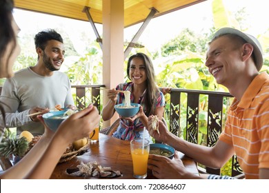 Group Of Young People Talking While Eating Noodles Soup Traditional Asian Food Friends Dining Together Relationship And Communication Concept