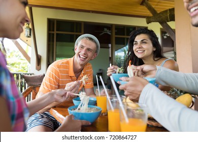 Group Of Young People Talking While Eating Noodles Soup Traditional Asian Food Friends Dining Together Relationship And Communication Concept