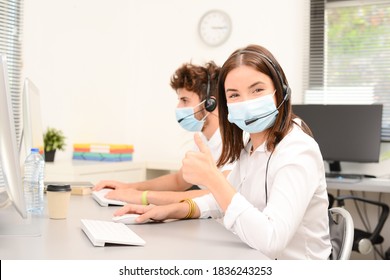 group of young people telephone operator with headset working in office medical helpline service call center support business with a surgical mask protection