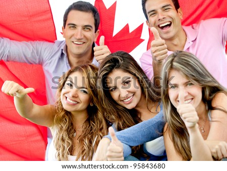 Group of young people with thumbs up and the flag of Canada