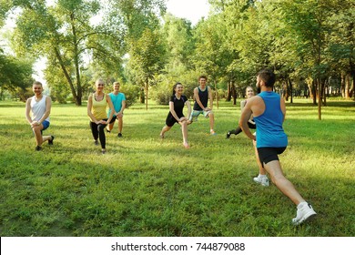 Group Of Young People Training In Park