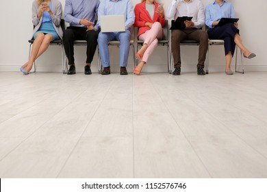 Group Of Young People Waiting For Job Interview On Chairs