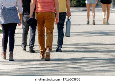 A Group Of Young Peoples Walking In The Park With Nitrous Oxide Tank Commonly Known As Laughing Gas (Distikstofmonoxide) National Holiday Kings Day Or Koningsdag In Dutch, Amsterdam, Netherlands.