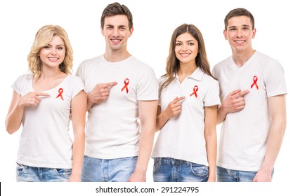 Group Of Young Positive People With Red Ribbon Supporting AIDS HIV Prevention. White Background.